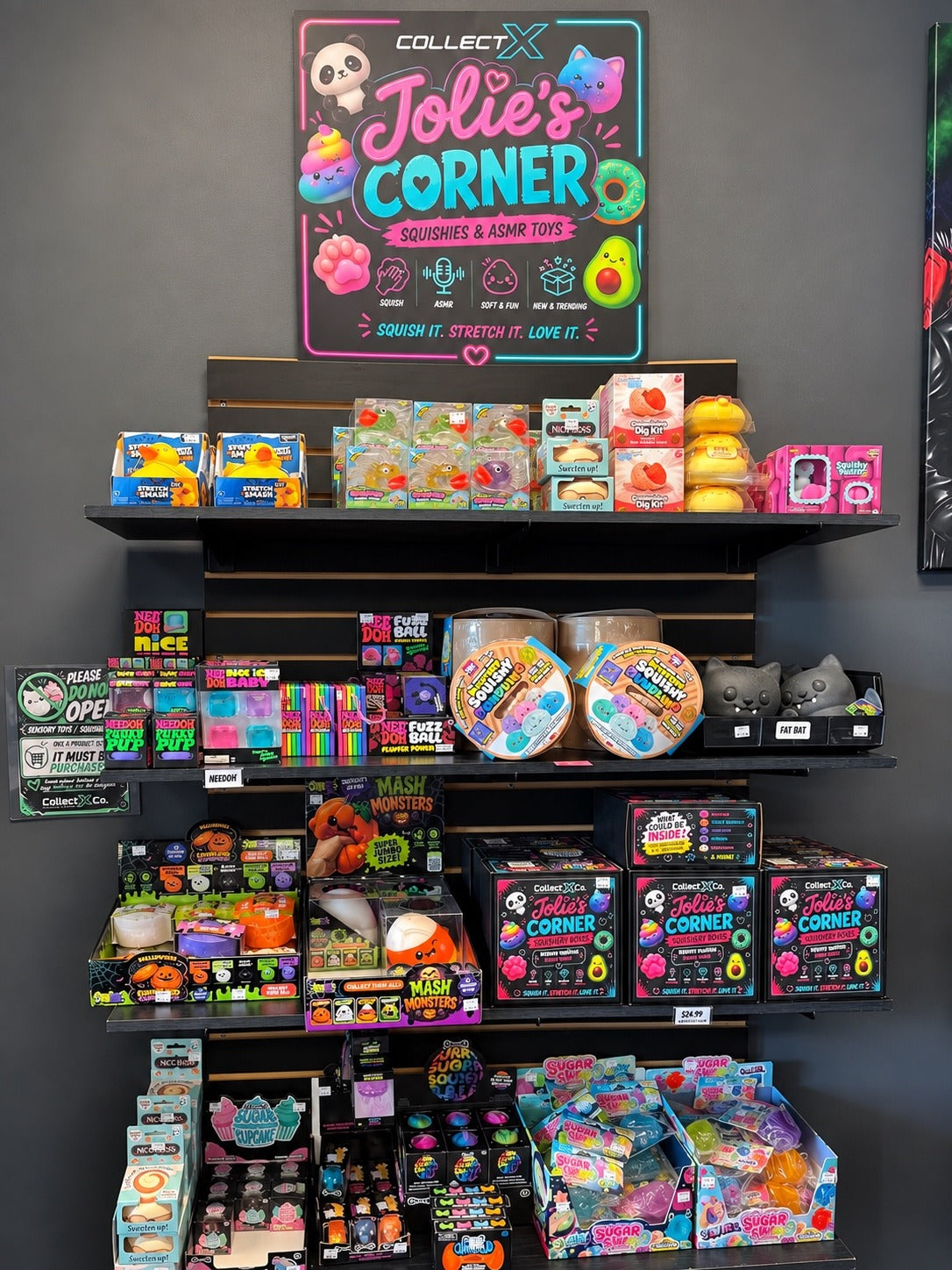 The full Jolie’s Corner sign and wall display of squishies, sensory toys, and mystery boxes