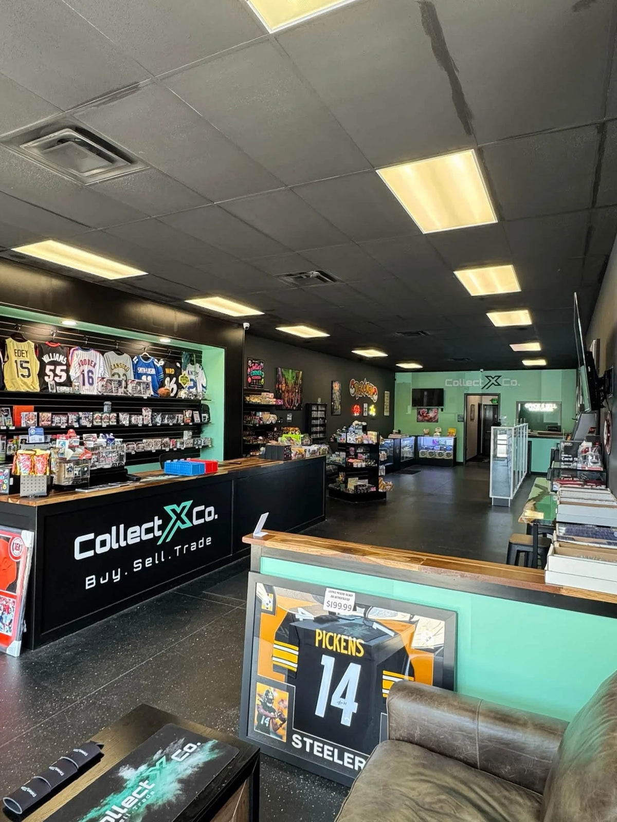 Inside CollectX Co., with the front counter, card displays, memorabilia, and seating area